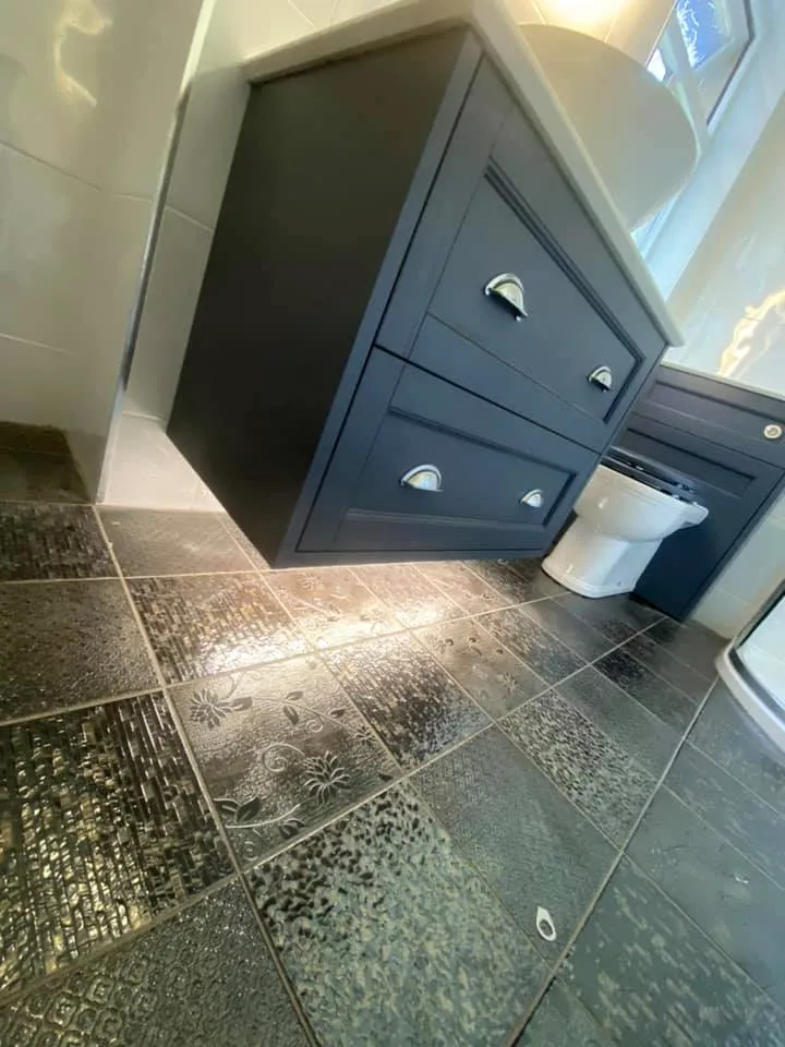 Navy vanity on patterned floor