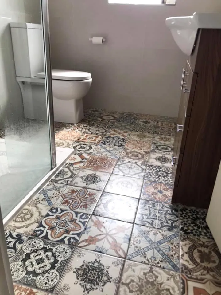 Bathroom with a patterned tiled floor