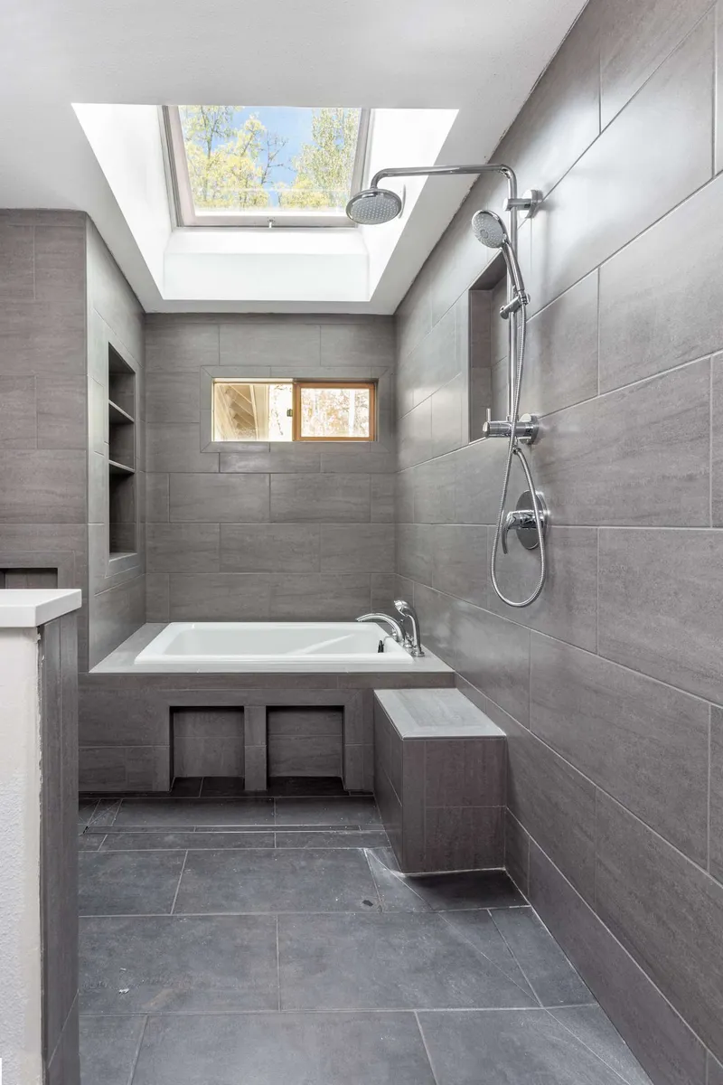 Large-format grey porcelain tiles in a shower room